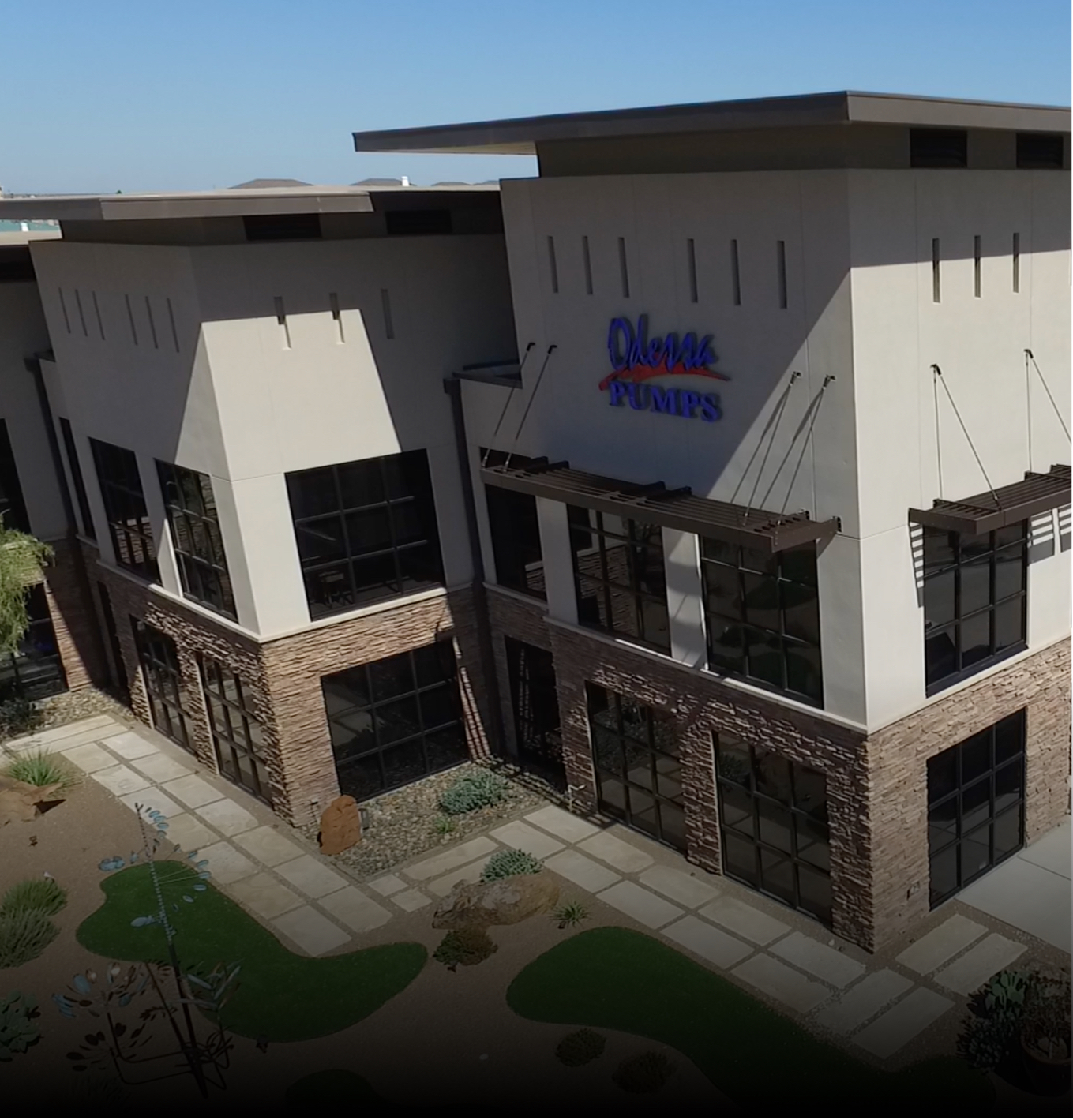 Angled front view of stucco commericial build for pipeline construction in Midland TX. Featuring brick facade and steel frame